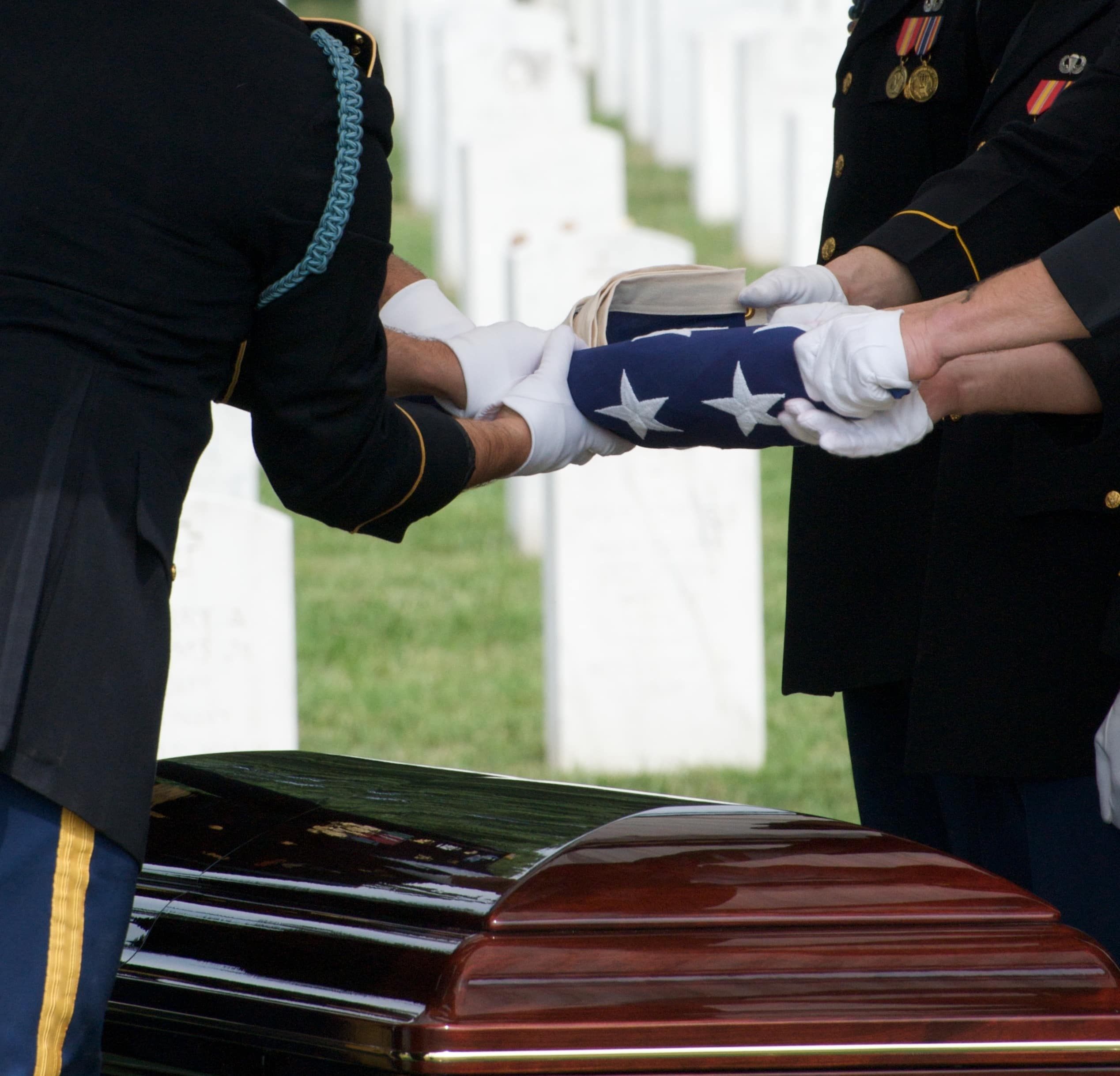 Handing off the flag at a veteran funeral .